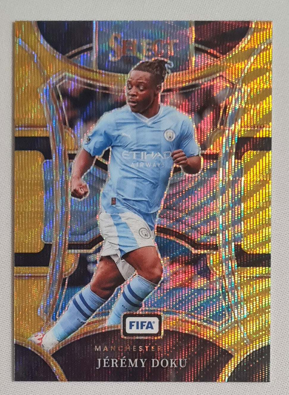 Jeremy Doku - 2023/24 Panini Select FIFA Soccer Prizm Man City #114 Mezzanine Gold Wave/10